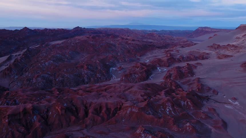 Mountains and rugged terrain stretch to the horizon