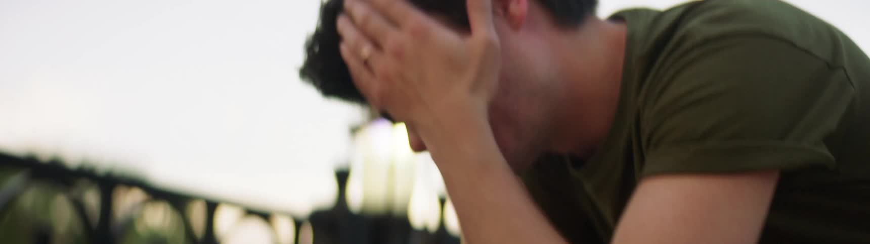 A white man wipes his face and hair after exercising outdoors