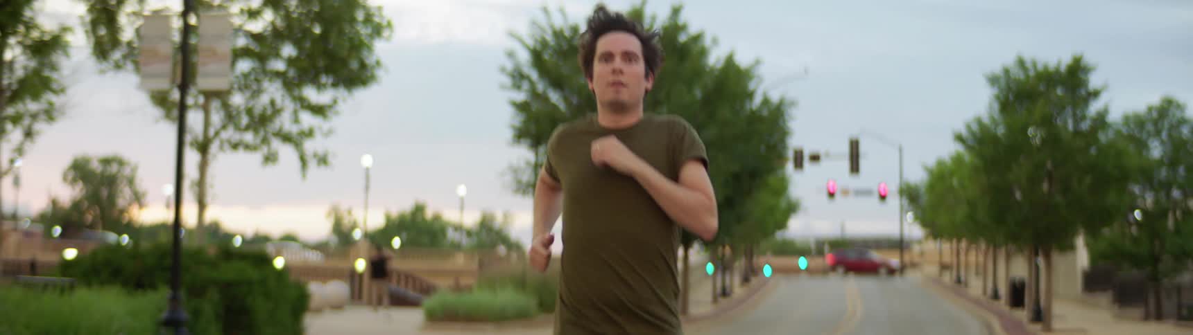 A man is jogging outdoors in a city