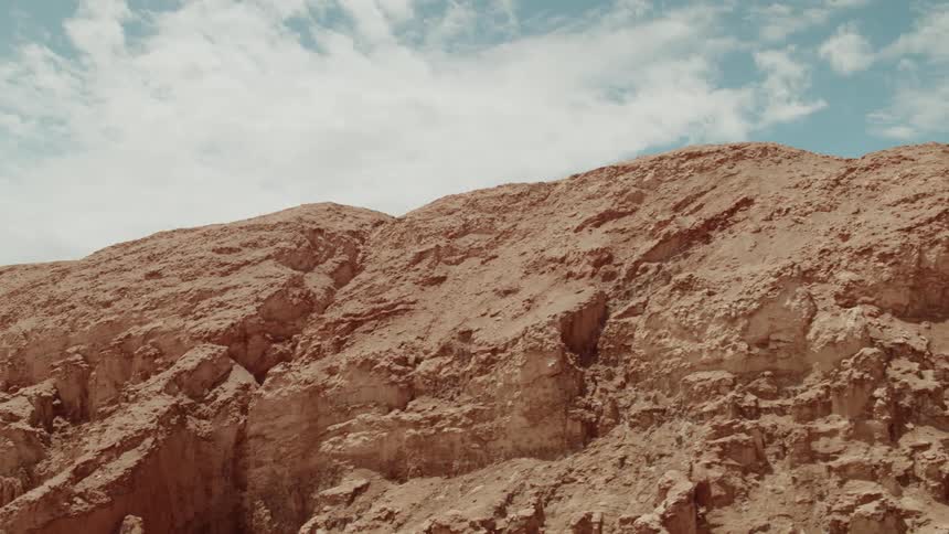 Natural cracks and valleys form on the side of a canyon