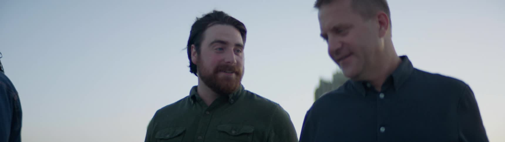 A group of friends walk through the city talking and laughing