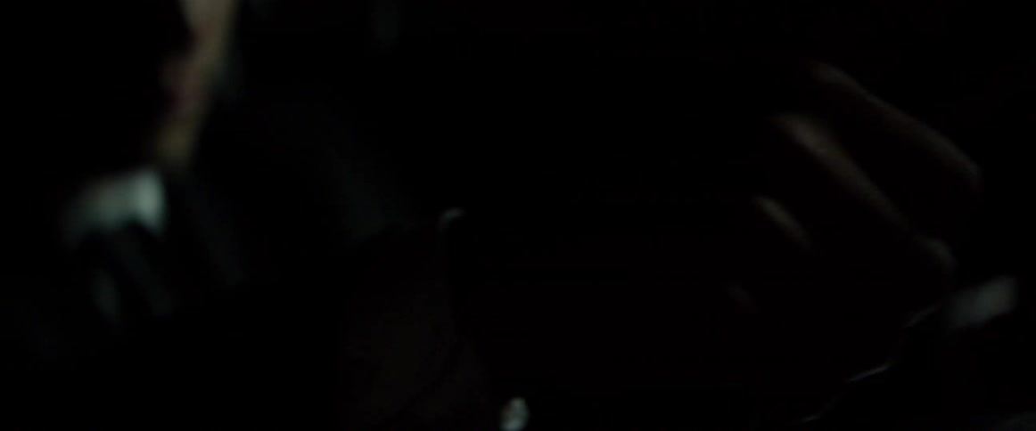 A person is shaking very fast in a dark area
