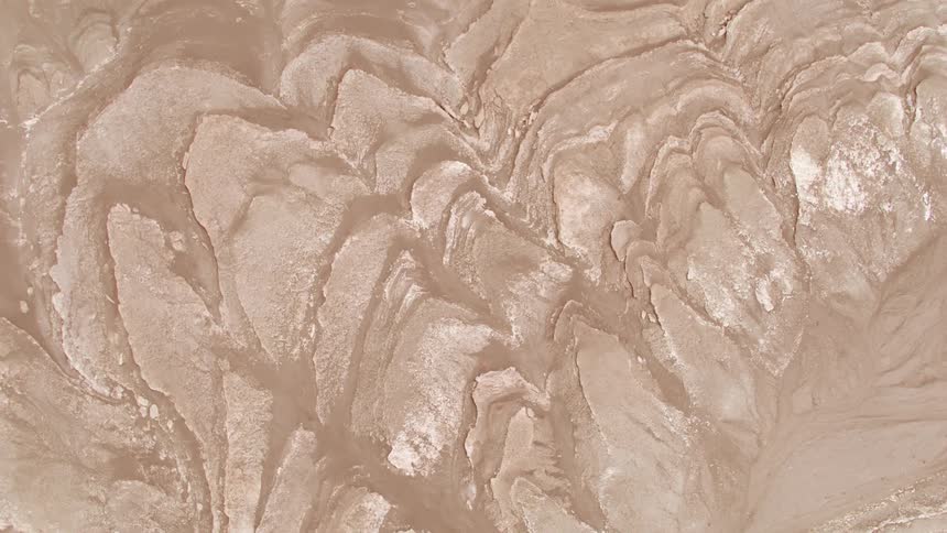 Crevices and grooves on a rock with some white dust