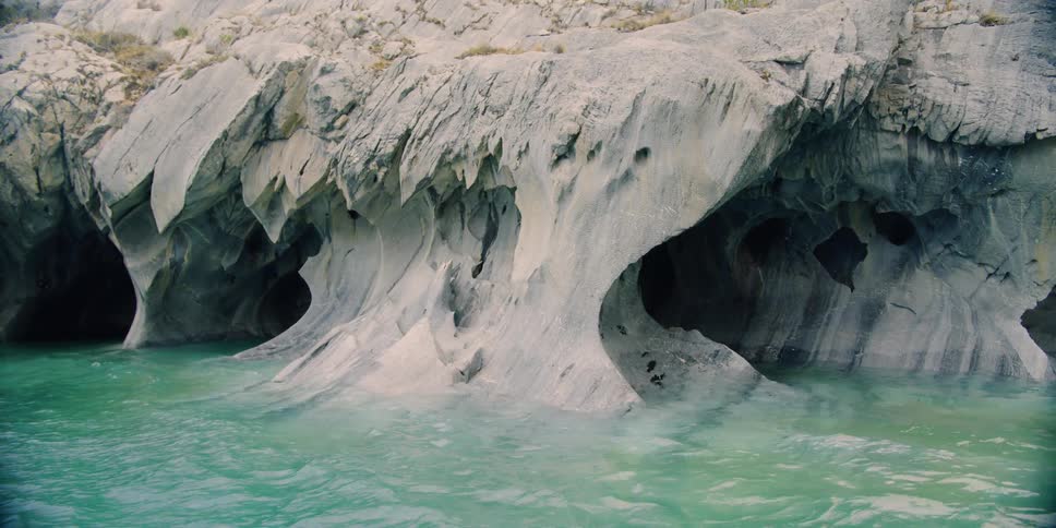 Water lapping against a cliff on the shore