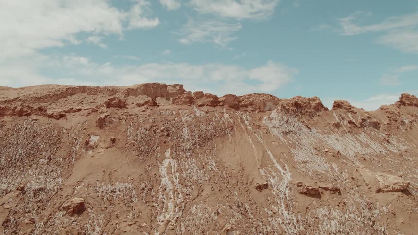 A brown rocky ridge on a bright blue sky day