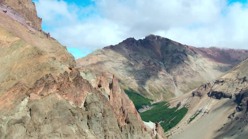 A forest sits in a mountain valley