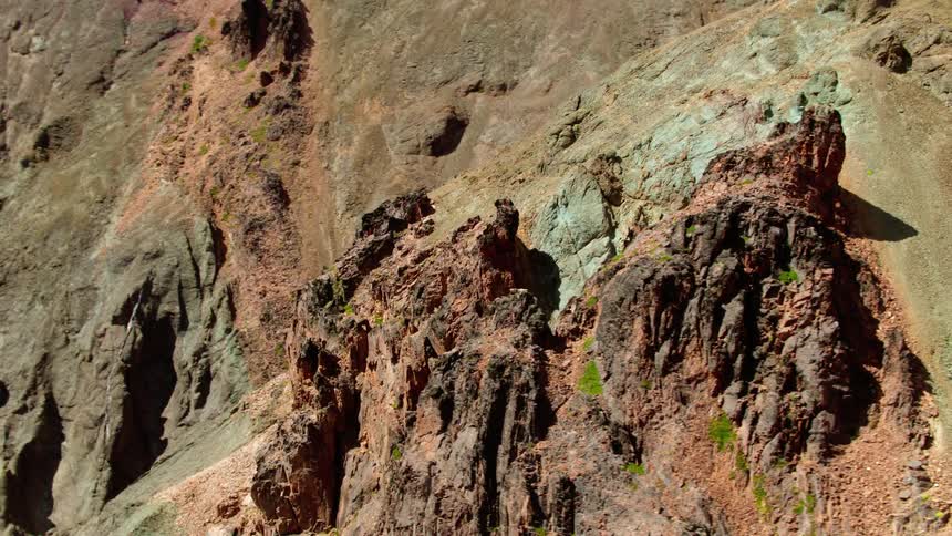 Rock formations rise out of the side of a mountain