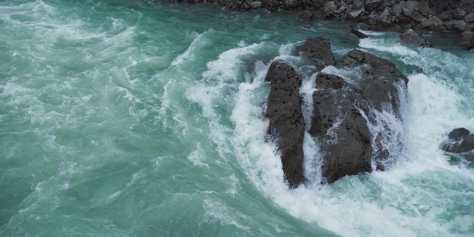 River water flowing over rocks and streaming through the cracks