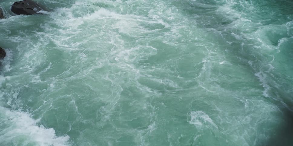 Close up top view of waterfall rapidly flowing down