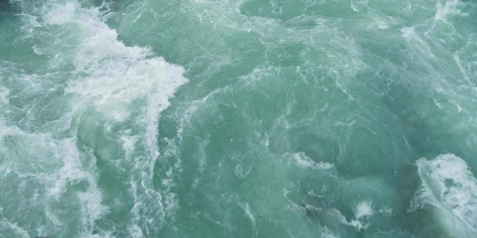 A large volume of water flows and froths