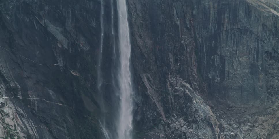 Waterfall cascades down the side of a mountain