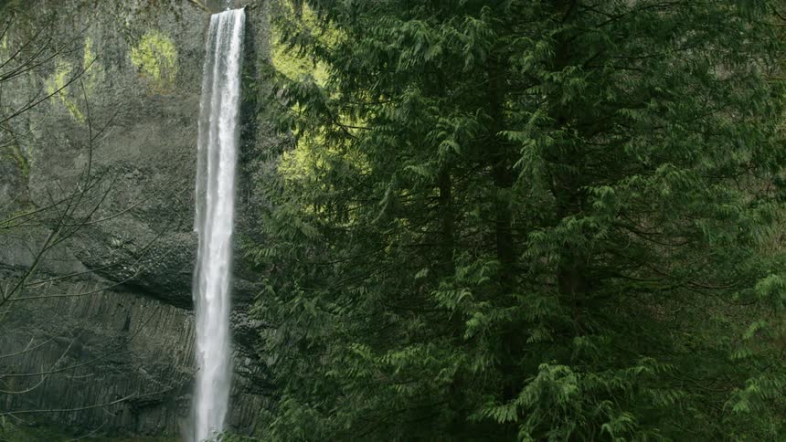Waterfall pouring over a steep cliff in the forest