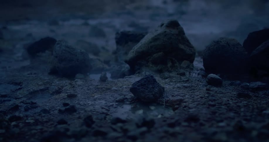 Vapor rises from small bubbling puddle in bare ground