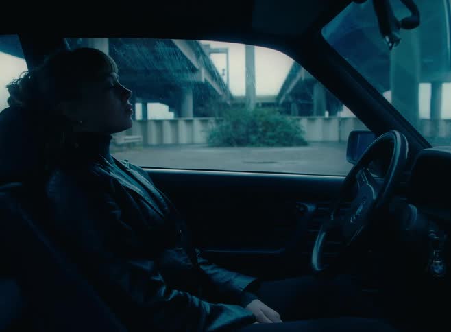 A woman is sleeping in a car