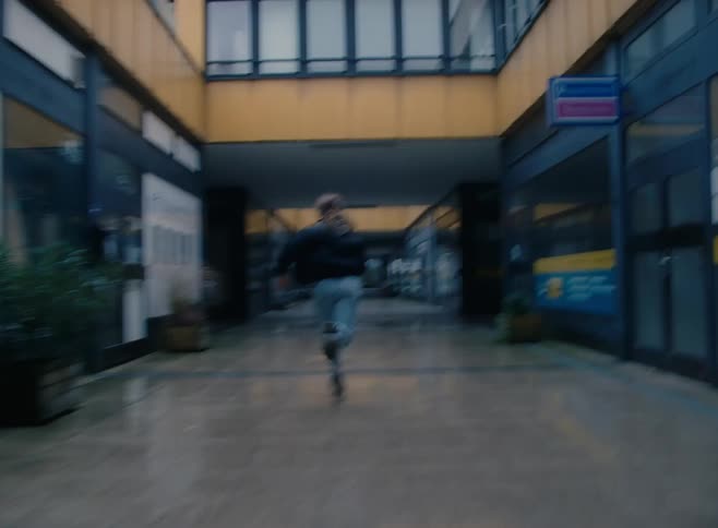 Someone runs through the shopping mall
