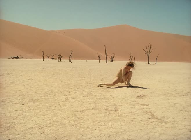 Woman performs interpretative dance in the desert