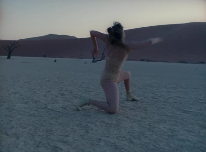 Woman practices dance moves in the desert