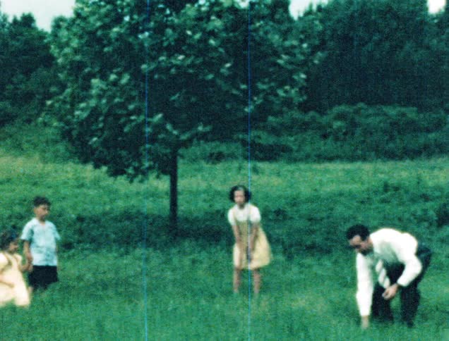 A father plays ball toss with his three children