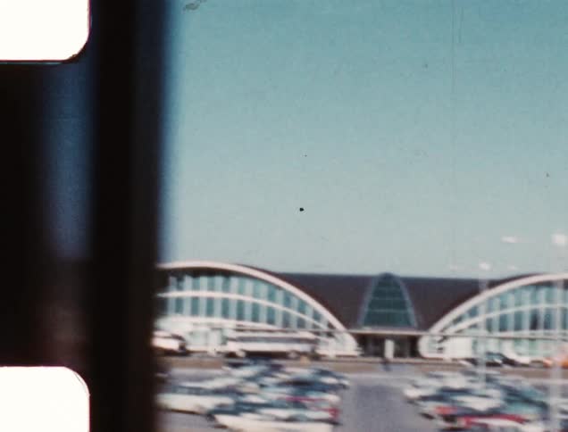 Cars parked in a parking lot of an airport terminal