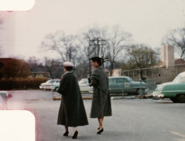 Vintage film of a group of women walking on a parking lot