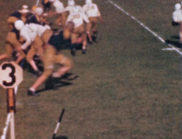 Two teams are playing a game of football on the field