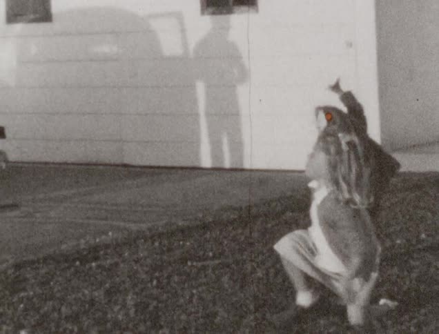 Several young white children run around a yard playing