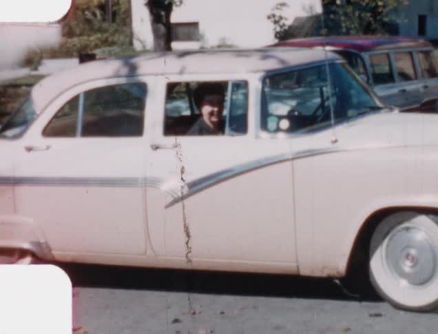 Vintage footage of happy woman sitting in a pink cadillac