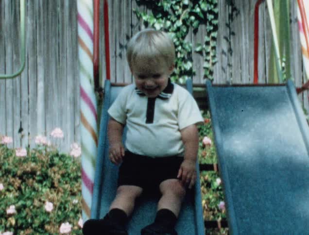 A child has fun sliding in the yard