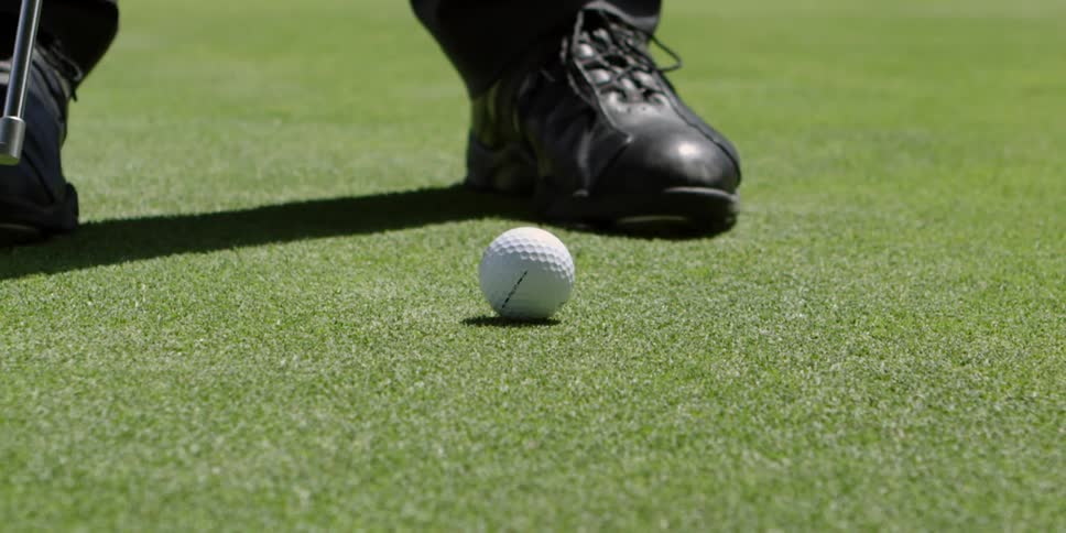 A person slowly puts the ball