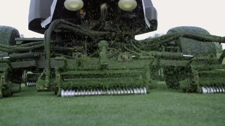 Close up of riding lawn mower cutting the lawn