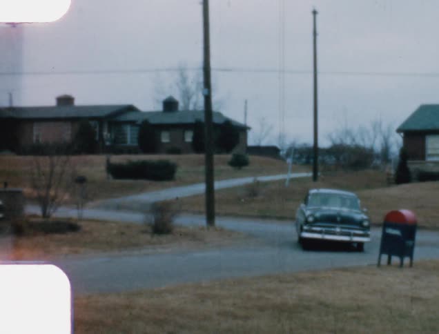 A vehicle drives through a neighborhood