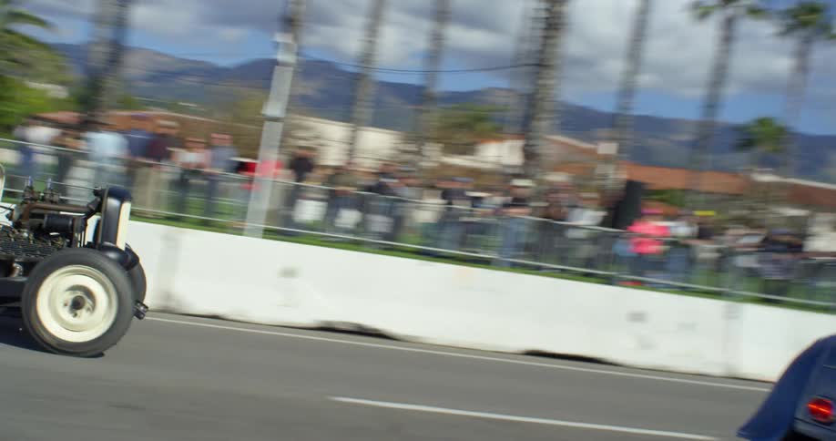 Roadsters crossing the finish line at racing event at the beach