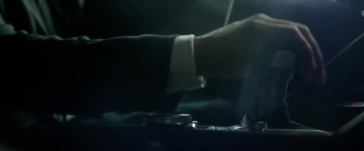 Man in sports car putting his hand on the shifter