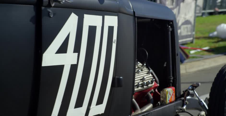 A car with a home built engine drives down a city street turned into a racetrack