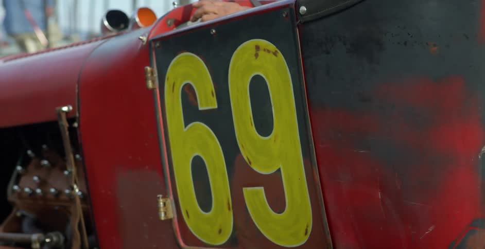 Vintage red sports race car with number 69 on the door