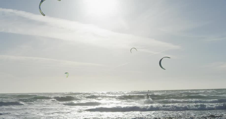 The people are kite boarding in the ocean