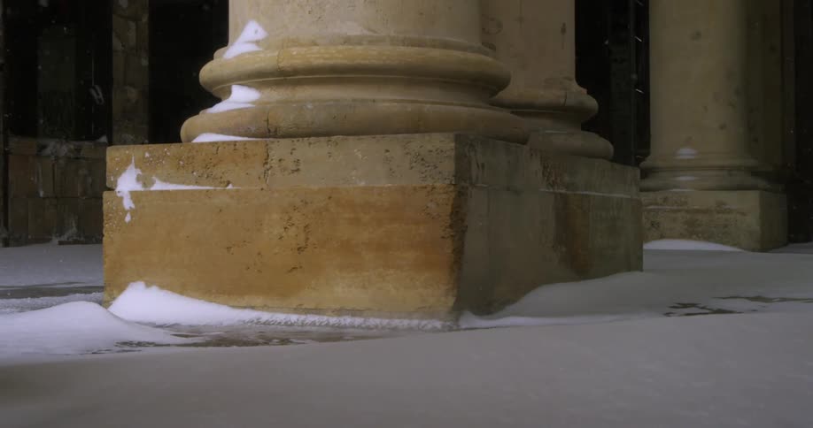 Snow falling at the base of a pillar