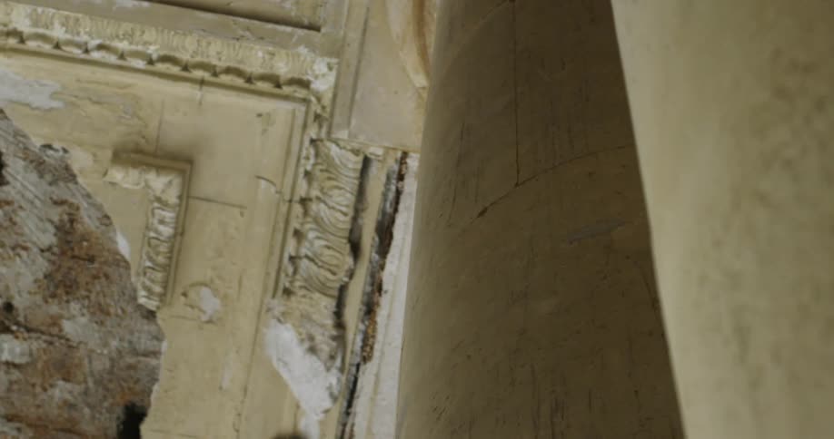 An old classical style building with severe damage to its ceiling