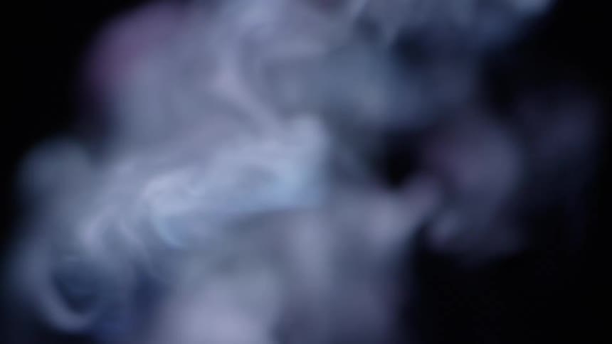 A plume of smoke blows and drifts upwards