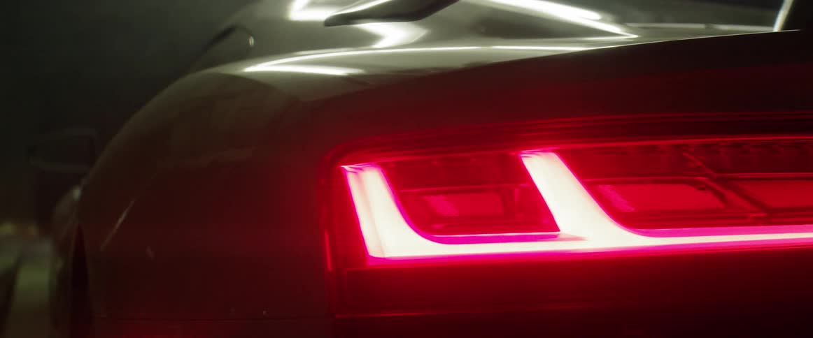 A car tail light is lit on a car as it is shown