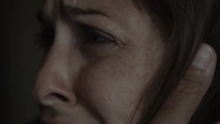Woman's eyes as she is being comforted