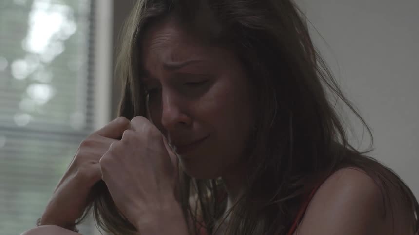 A woman cries and pulls her hair