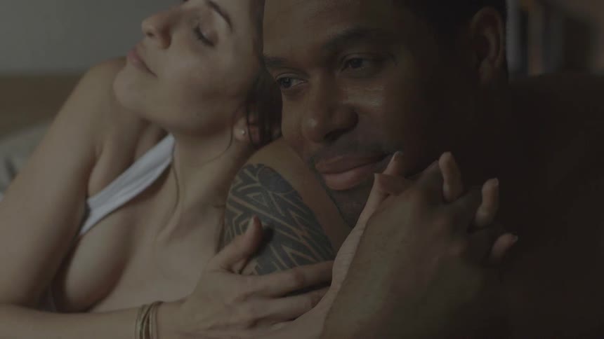 A man and woman cuddle and hold hands