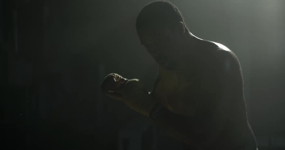 Man in boxing gloves punching into the air