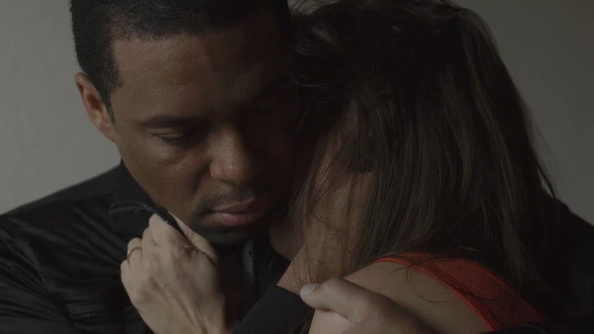 A man hugs a distressed woman