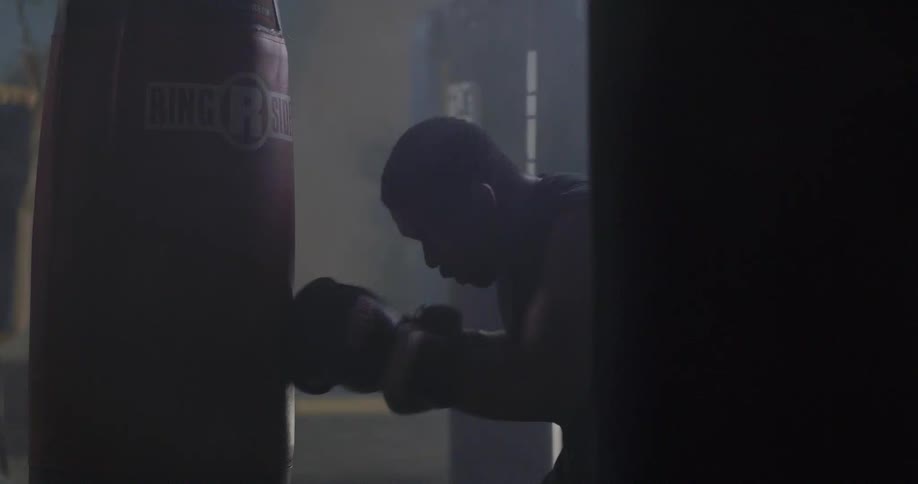 A boxer trains using a punching bag