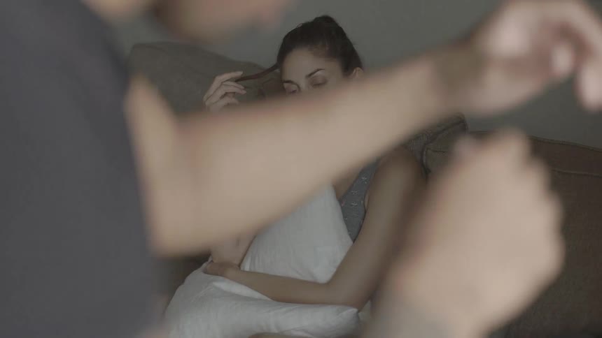 A woman watches a man exercise