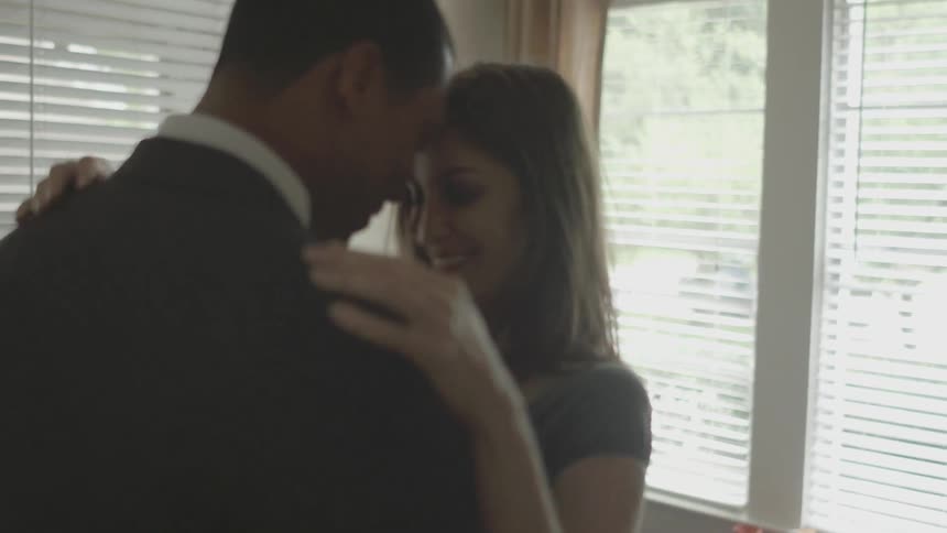 Man and woman dancing and being romantic in a kitchen