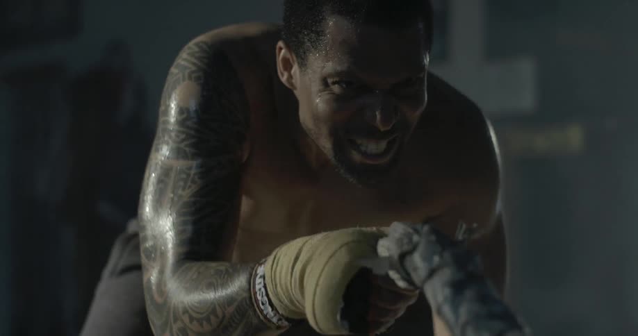 A man exercising and sweating in a gym