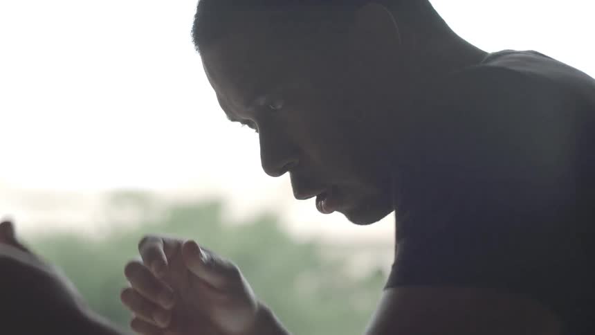 A man making punching and sparring motions